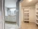 Bathroom with double sinks, tile flooring, and linen closet at 2732 Lone Feather Dr, Orlando, FL 32837
