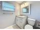 Bathroom vanity features updated fixtures, marble countertop, storage cabinets, and ample lighting at 2732 Lone Feather Dr, Orlando, FL 32837