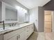 Bathroom featuring a double sink vanity with granite countertops and decorative mirrors at 2732 Lone Feather Dr, Orlando, FL 32837