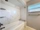 Bathroom features modern tub shower with tile surround and shelving and sleek, modern hardware at 2732 Lone Feather Dr, Orlando, FL 32837