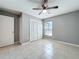 Bright bedroom with a ceiling fan, tile flooring, and a large closet for ample storage at 2732 Lone Feather Dr, Orlando, FL 32837