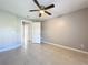 Bedroom includes closet, ceiling fan, and tile flooring at 2732 Lone Feather Dr, Orlando, FL 32837