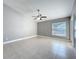 A light-filled bedroom features a ceiling fan, neutral walls, and tile flooring at 2732 Lone Feather Dr, Orlando, FL 32837