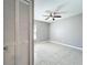 Bright bedroom with a ceiling fan, tile flooring, and a large closet for ample storage at 2732 Lone Feather Dr, Orlando, FL 32837