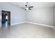 Bedroom featuring a vaulted ceiling, tile flooring, a ceiling fan, and neutral paint tones at 2732 Lone Feather Dr, Orlando, FL 32837