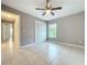 Bright bedroom with a ceiling fan, tile flooring, and a large closet for ample storage at 2732 Lone Feather Dr, Orlando, FL 32837