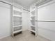 Walk-in closet with custom built-in shelving and tile flooring at 2732 Lone Feather Dr, Orlando, FL 32837