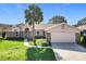 Charming home featuring a well-manicured lawn, brick detailing, and a convenient two-car garage at 2732 Lone Feather Dr, Orlando, FL 32837
