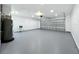 Large garage with an epoxy floor, utility sink, and ample space for vehicles and storage solutions at 2732 Lone Feather Dr, Orlando, FL 32837