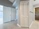 Hallway view of bedroom and bathroom features neutral walls, tile flooring and linen closet at 2732 Lone Feather Dr, Orlando, FL 32837
