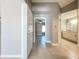 Hallway view leading to the bedroom and bathroom features tile floors and neutral walls at 2732 Lone Feather Dr, Orlando, FL 32837