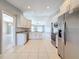 This beautifully renovated kitchen features modern stainless steel appliances and stylish white cabinets at 2732 Lone Feather Dr, Orlando, FL 32837