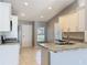 Modern kitchen features stainless steel appliances and granite countertops, complemented by tile flooring at 2732 Lone Feather Dr, Orlando, FL 32837