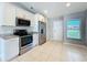 This kitchen features stainless steel appliances, solid countertops and stylish white cabinets at 2732 Lone Feather Dr, Orlando, FL 32837