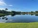 Beautiful lake view in a tranquil setting with reflections of trees on the water at 2732 Lone Feather Dr, Orlando, FL 32837