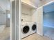Convenient laundry closet featuring a washer and dryer with wire shelving for organized storage solutions at 2732 Lone Feather Dr, Orlando, FL 32837