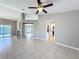 Open-concept living room with tile floors, fireplace, and access to kitchen and screened pool area at 2732 Lone Feather Dr, Orlando, FL 32837