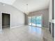 Bright living room featuring tile floors, a chandelier, and sliding doors to the screened pool area at 2732 Lone Feather Dr, Orlando, FL 32837