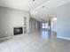Bright living room with a fireplace, tile floors and chandelier, perfect for entertaining at 2732 Lone Feather Dr, Orlando, FL 32837
