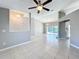 Spacious living room featuring tiled floors, two chandeliers, a ceiling fan and access to the pool area at 2732 Lone Feather Dr, Orlando, FL 32837