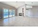 Open-concept living room featuring tile flooring, a fireplace, and sliding doors to the pool area at 2732 Lone Feather Dr, Orlando, FL 32837