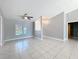 Inviting living room featuring tiled floors, a ceiling fan and natural light from a large window at 2732 Lone Feather Dr, Orlando, FL 32837