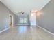 Inviting living room featuring tiled floors, a ceiling fan and natural light from a large window at 2732 Lone Feather Dr, Orlando, FL 32837