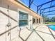 Covered patio with convenient outdoor shower next to the pool, ideal for rinsing off after a swim at 2732 Lone Feather Dr, Orlando, FL 32837