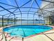 Sparkling pool with screened enclosure offering stunning lake views, perfect for relaxation and recreation at 2732 Lone Feather Dr, Orlando, FL 32837