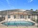 Enclosed pool area showcasing the screened enclosure, pool, and outdoor space at 2732 Lone Feather Dr, Orlando, FL 32837