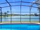 Inviting pool inside a screened enclosure with beautiful lake views, perfect for outdoor enjoyment and relaxation at 2732 Lone Feather Dr, Orlando, FL 32837