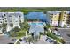 Aerial view of a community clubhouse and pool overlooking bay waters and boat docks at 3 Riverwalk Dr # 506, New Smyrna Beach, FL 32169