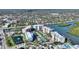 Aerial view showcasing the waterfront condo complex, pool, and surrounding landscape at 3 Riverwalk Dr # 506, New Smyrna Beach, FL 32169