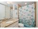 Well-lit bathroom with attractive shower curtain and vanity, offering a comfortable and stylish space for daily routines at 3 Riverwalk Dr # 506, New Smyrna Beach, FL 32169