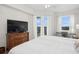 Comfortable bedroom with a view of the outdoors from the large windows at 3 Riverwalk Dr # 506, New Smyrna Beach, FL 32169