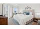 Bright bedroom featuring a plush bed, ceiling fan, and natural light from the window at 3 Riverwalk Dr # 506, New Smyrna Beach, FL 32169