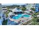 Community pool with grilling areas and nearby spa surrounded by tropical landscaping at 3 Riverwalk Dr # 506, New Smyrna Beach, FL 32169
