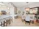 Inviting dining area with stylish chandelier, dining table, and bar seating, perfect for entertaining guests and Gathering meals at 3 Riverwalk Dr # 506, New Smyrna Beach, FL 32169