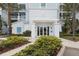 Inviting entrance to condo building with lush landscaping, creating a welcoming atmosphere for residents and guests at 3 Riverwalk Dr # 506, New Smyrna Beach, FL 32169