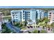 Condo building with landscaped grounds, dedicated parking, and inviting exterior design at 3 Riverwalk Dr # 506, New Smyrna Beach, FL 32169