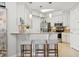 Bright kitchen with white cabinetry, bar seating and stainless steel appliances at 3 Riverwalk Dr # 506, New Smyrna Beach, FL 32169