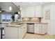 Bright kitchen with white cabinets, a stainless steel dishwasher, and bar seating at 3 Riverwalk Dr # 506, New Smyrna Beach, FL 32169