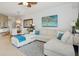 Open-concept living room featuring a comfortable sectional sofa and stylish decor at 3 Riverwalk Dr # 506, New Smyrna Beach, FL 32169