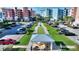 Aerial view of shuffleboard court next to an outdoor picnic area and colorful condominium buildings at 3 Riverwalk Dr # 506, New Smyrna Beach, FL 32169