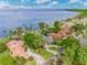 Stunning aerial view of luxurious waterfront homes with private docks and lush landscaping at 303 Waterwood Dr, Yalaha, FL 34797