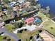 Stunning aerial view of a waterfront home with a pool and private boat dock on a canal leading to the lake at 303 Waterwood Dr, Yalaha, FL 34797