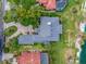 Aerial view of estate with direct beach access, large private pool, and multiple houses on the property at 303 Waterwood Dr, Yalaha, FL 34797