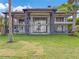 Gorgeous backyard with large windows and columns spanning two levels of the back of this luxury house at 303 Waterwood Dr, Yalaha, FL 34797