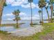 The white sand beach by this property includes a kayak or paddleboard for access to the water at 303 Waterwood Dr, Yalaha, FL 34797