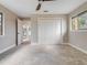 Bedroom with neutral paint, ceiling fan, closet, and a bright window with outdoor views at 303 Waterwood Dr, Yalaha, FL 34797